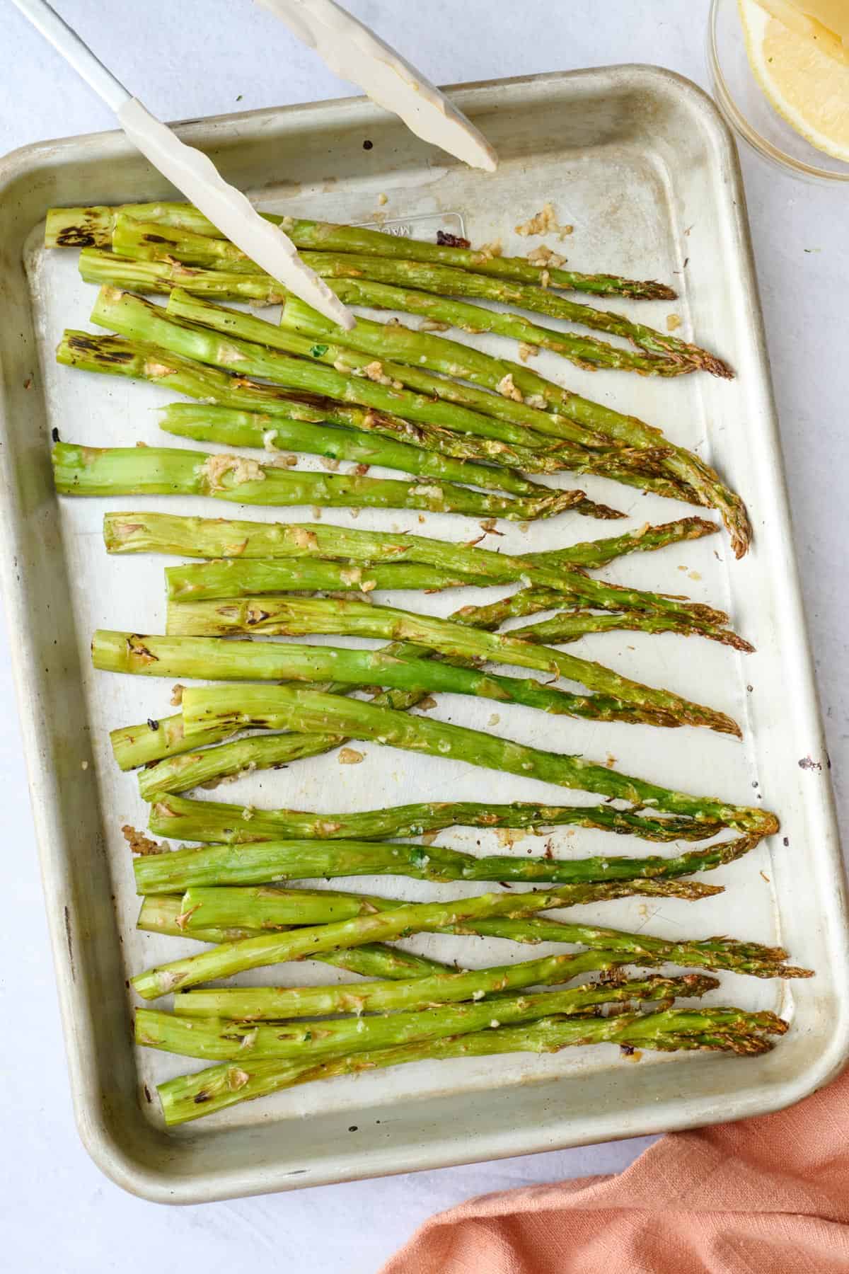 Crispy roasted asparagus on a sheet pan.