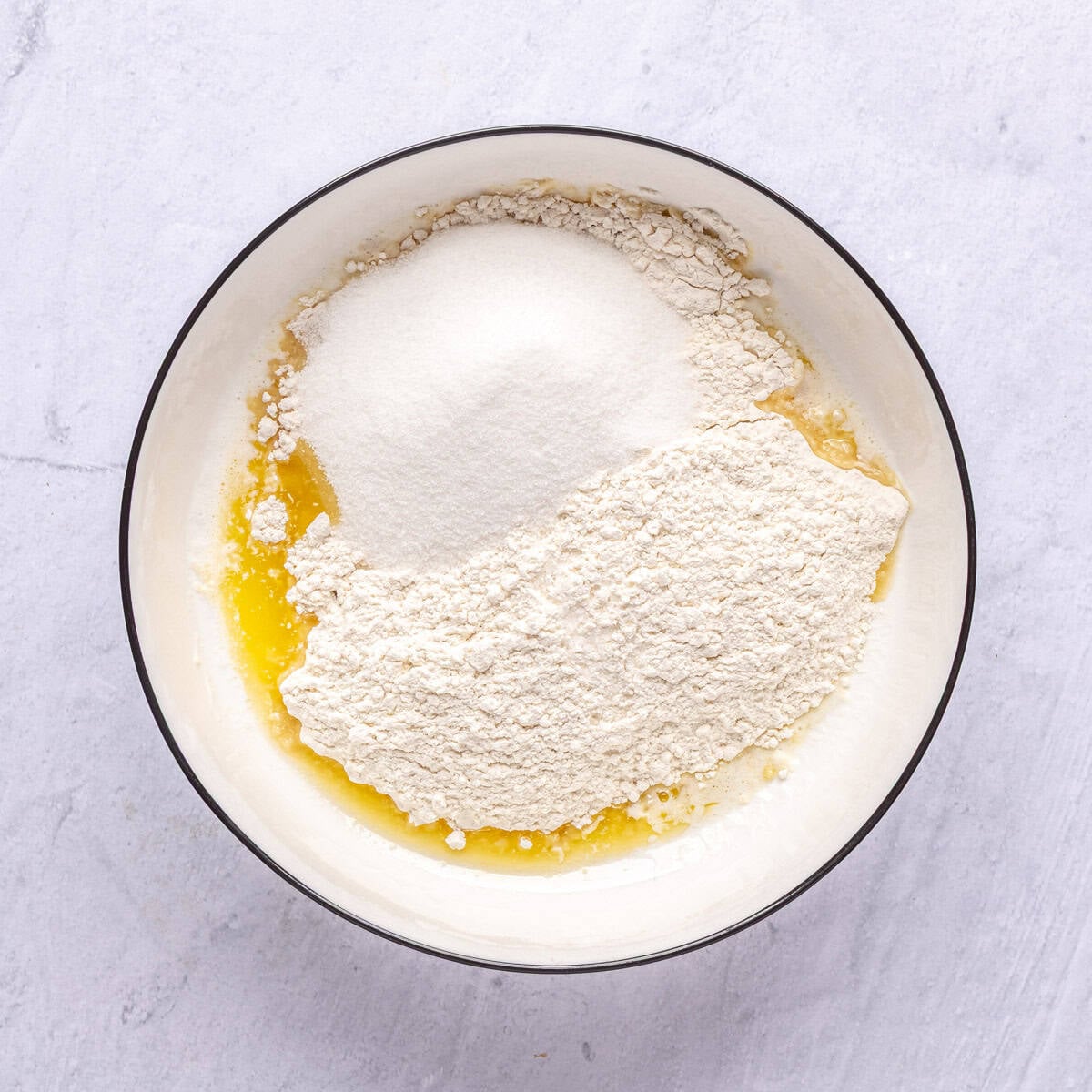 Melted butter, flour, sugar and salt in a large bowl before mixing.