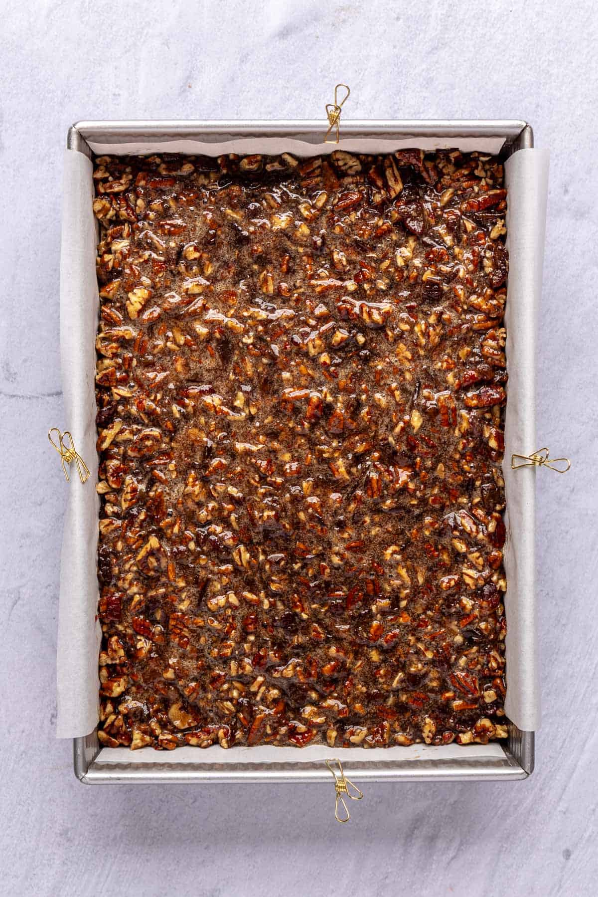 Date pecan filling added on top of the baked crust before baking.