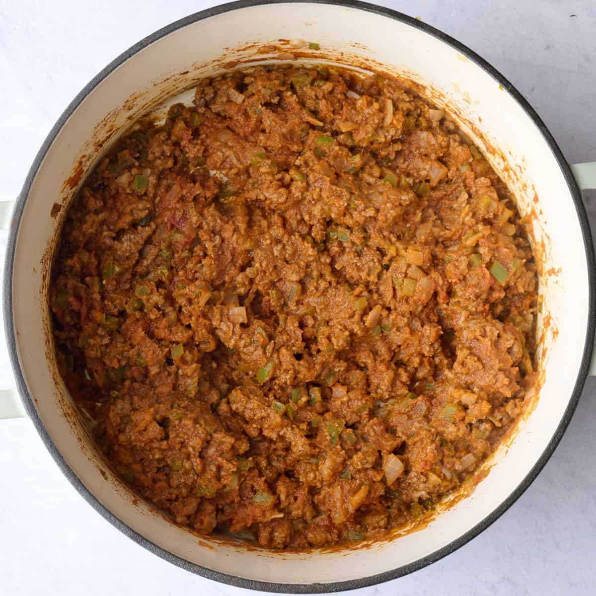 Thick pumpkin puree chili base with beef in a pot after cooking.
