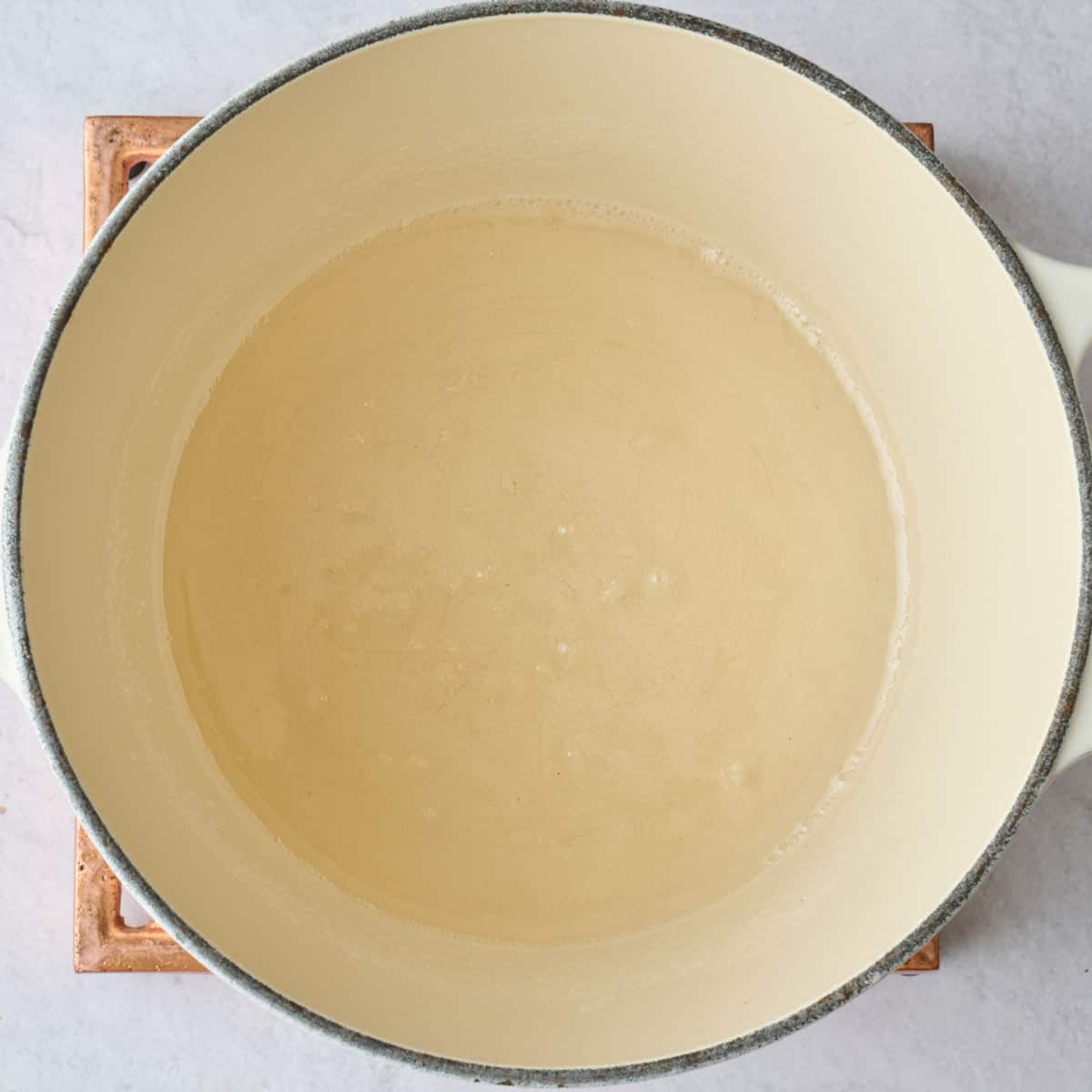 Bubbly simple syrup in a pot.