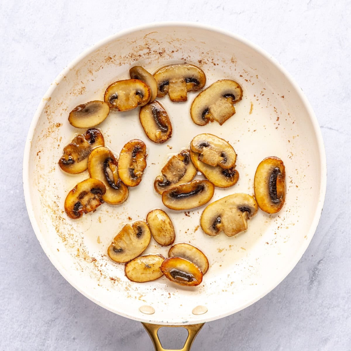 Mushrooms after sauteing with butter until softened and browned.