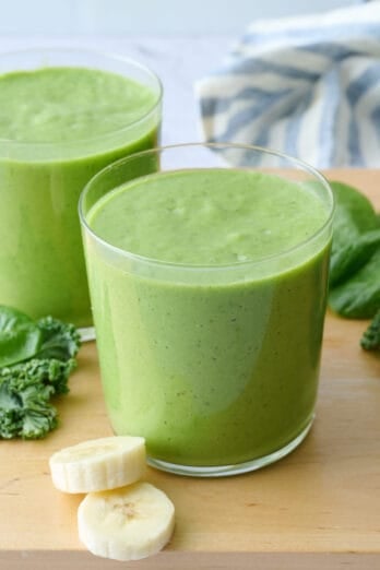 The best green smoothie recipe in two glasses, made with spinach, kale, avocado, pineapple and banana.