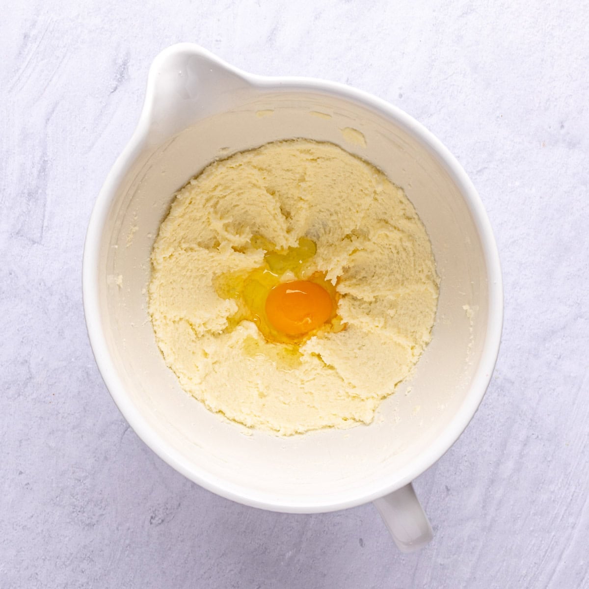 Butter and sugar after creaming with an egg added before combining.