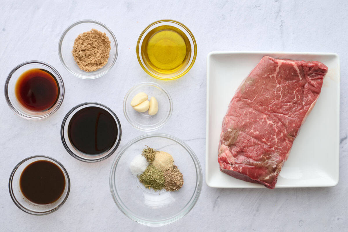 Ingredients for beef recipe: olive oil, soy sauce, balsamic vinegar, Worcestershire sauce, garlic, brown sugar, dried seasonings, and top round steak.