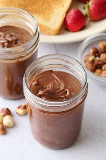 Homemade nutella recipe in small glass jars.