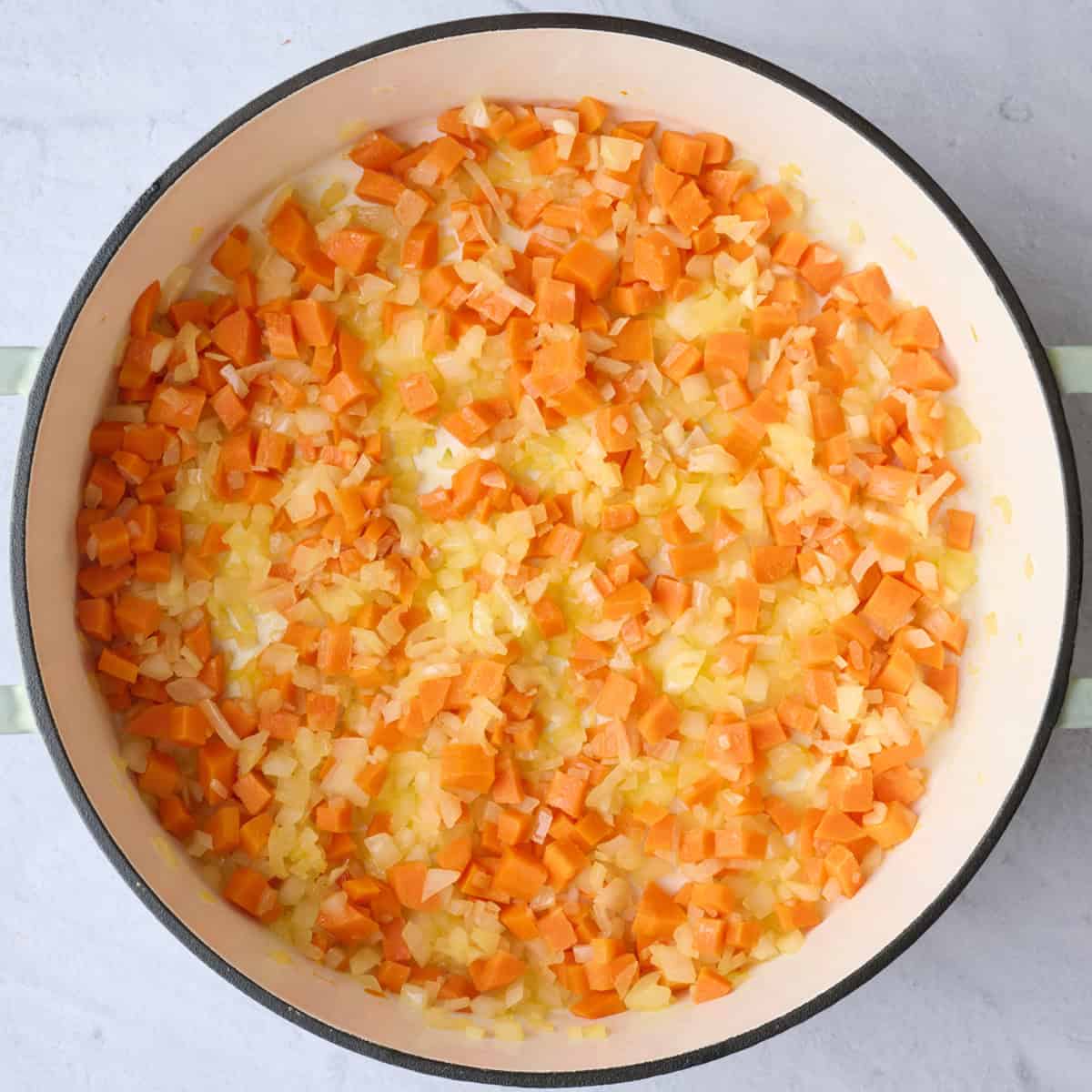 Onions and carrots in a pot after cooking for soup recipe.