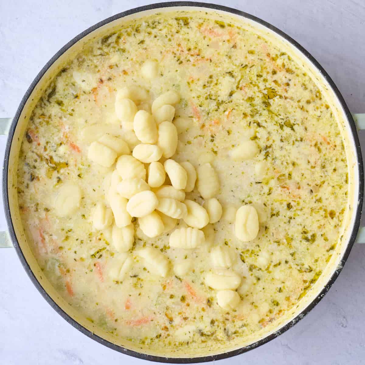 After chicken is cooked through with gnocchi added on top.