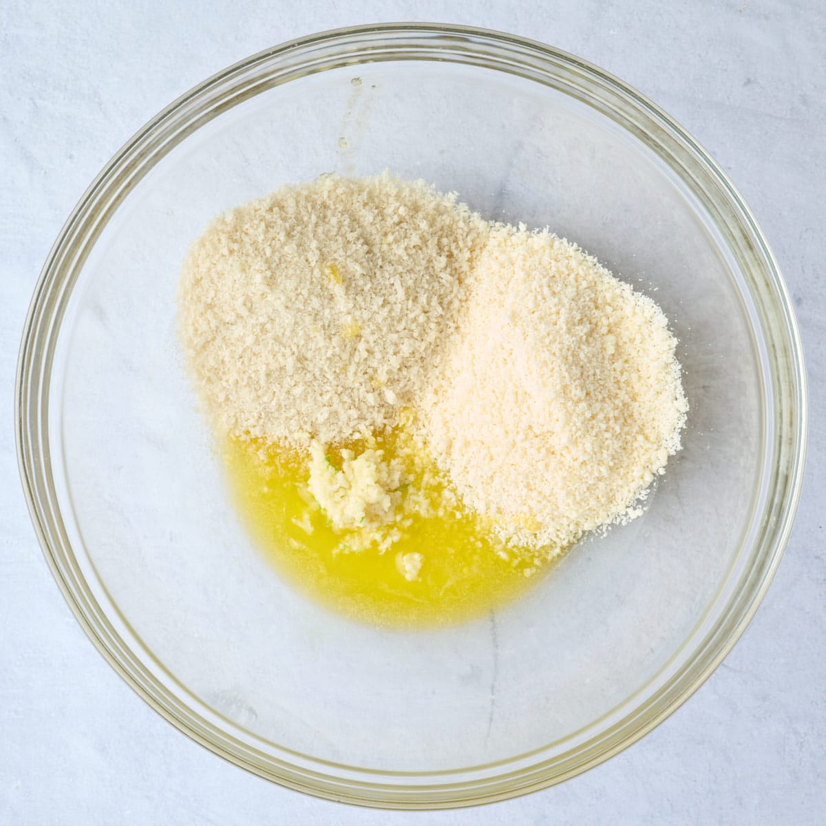 Garlic, parmesan, panko and melted butter in a large bowl before combining.
