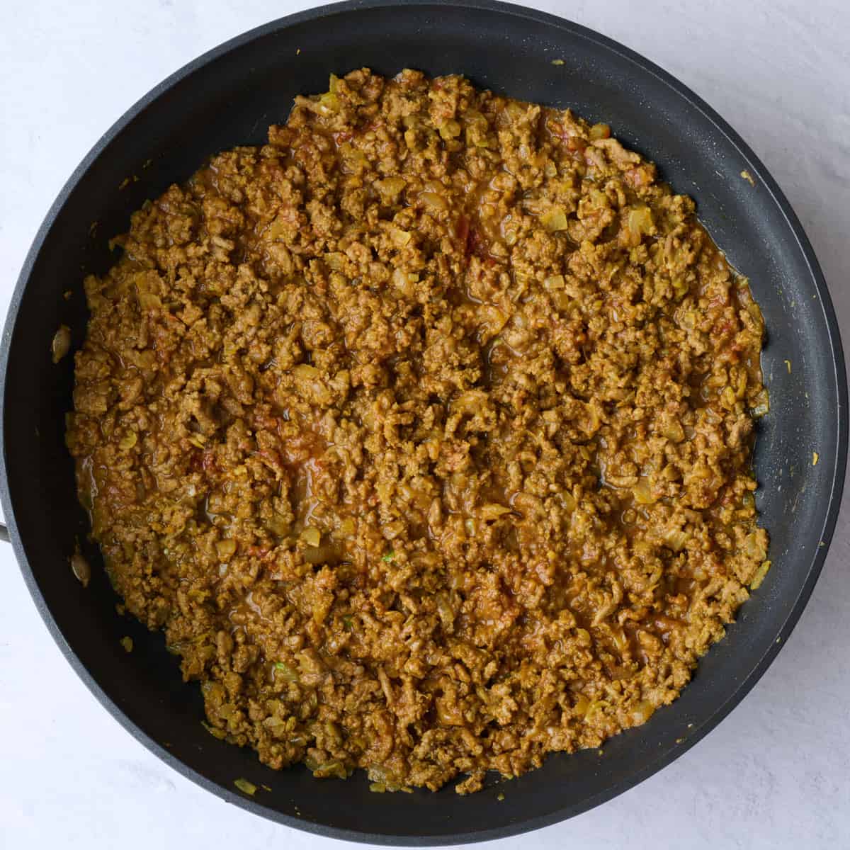 Ground beef curry mixture after tomato paste is cooked in.