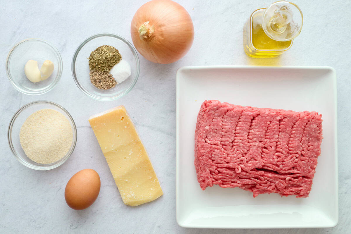 Ingredients for meatball recipe: ground beef, breadcrumbs, garlic, Italian seasoning, salt and pepper, egg, parmesan, onion, and oil.