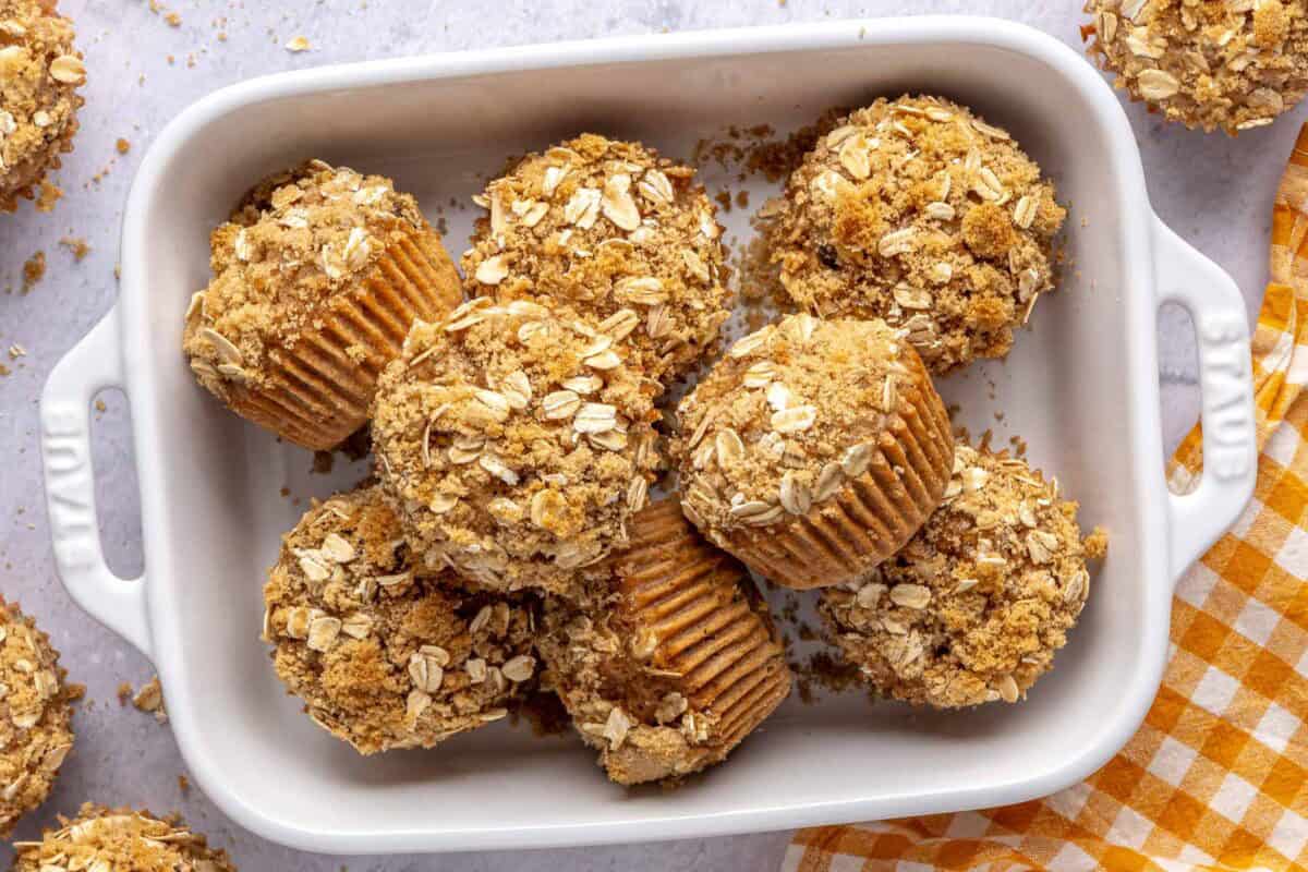 Brown sugar oatmeal muffins with raisins and a crumbly oat topping served in a dish.