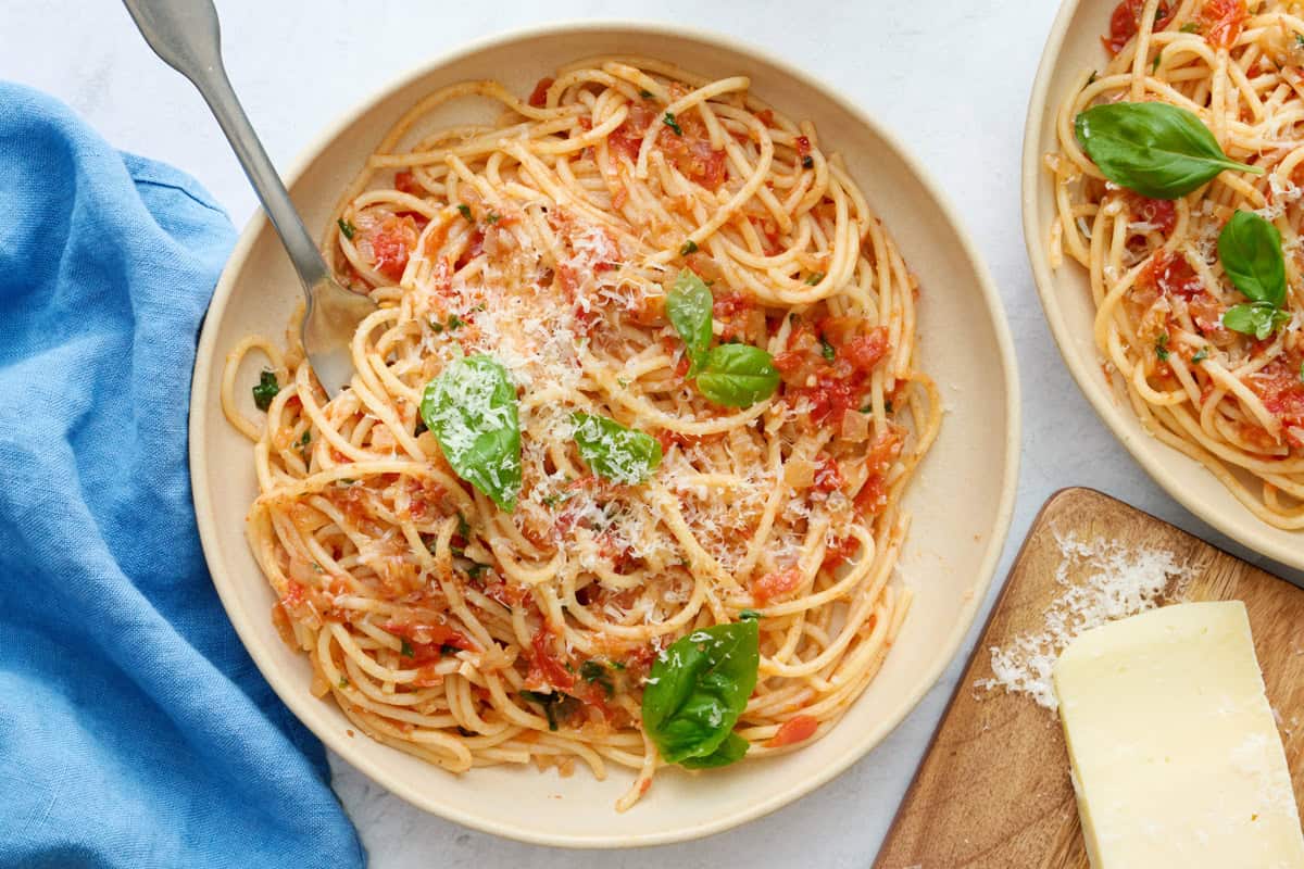 Homemade pasta pomodoro with parmesan cheese and fresh basil.