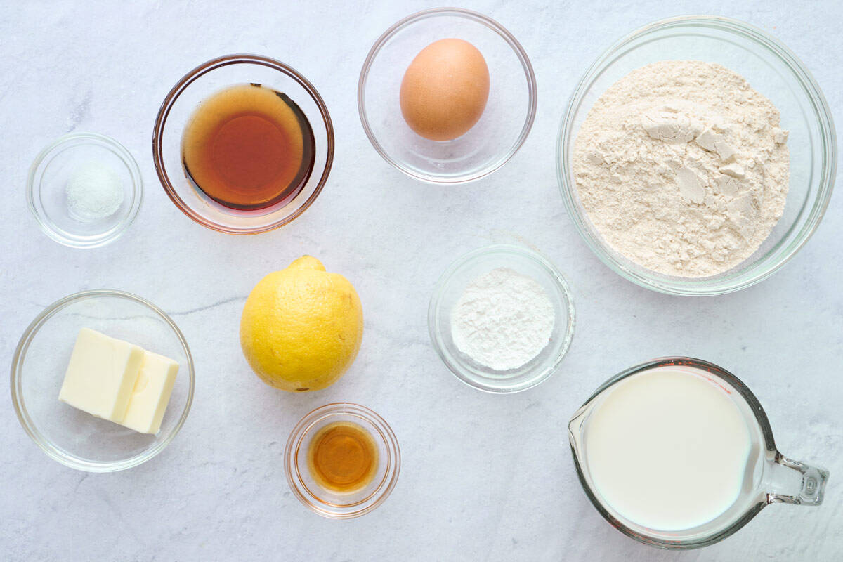 Ingredients for pancake recipe: salt, butter, maple syrup, lemon, egg, vanilla, baking powder, whole wheat flour, and milk.