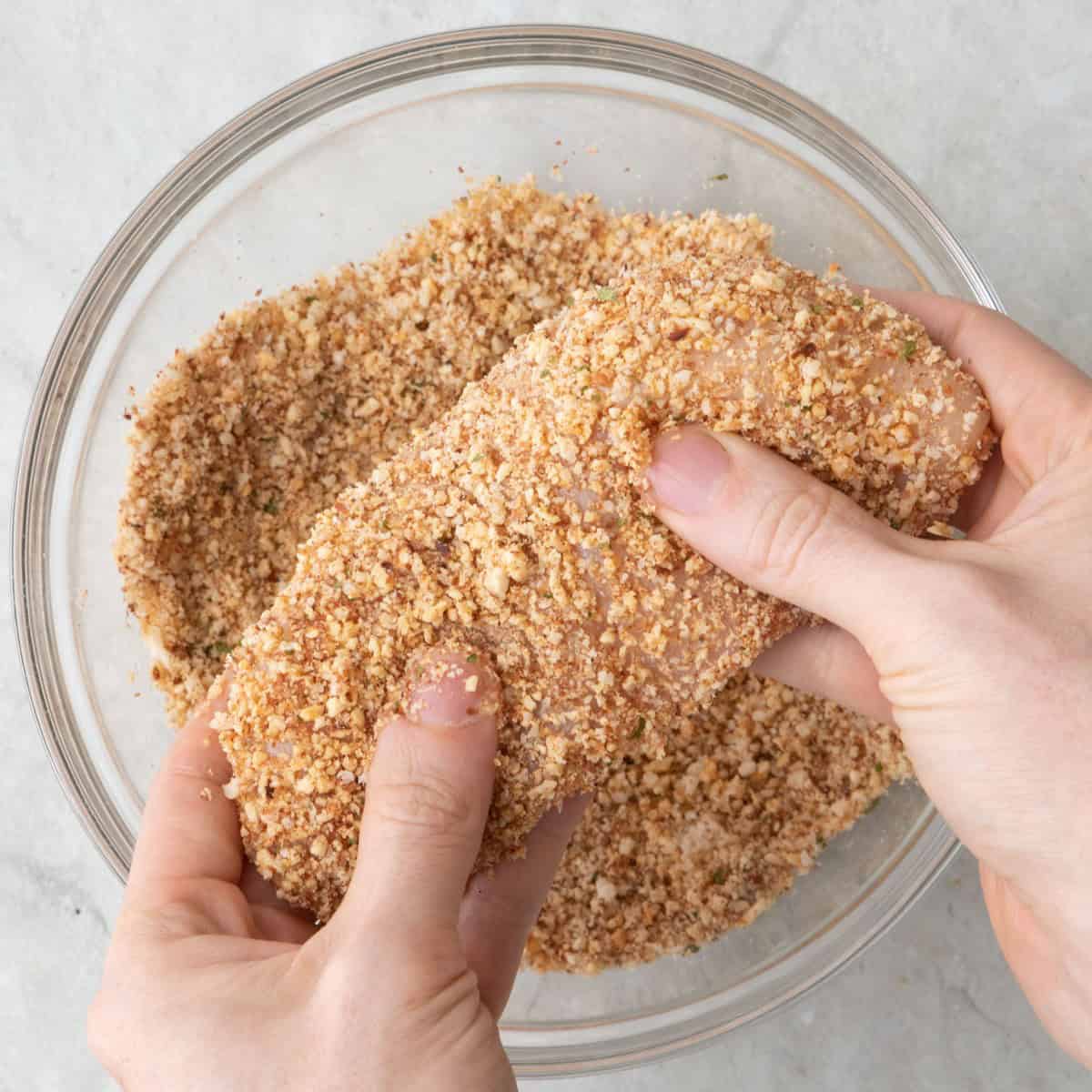 Egg coated chicken cutlets dredged in almond mixture.