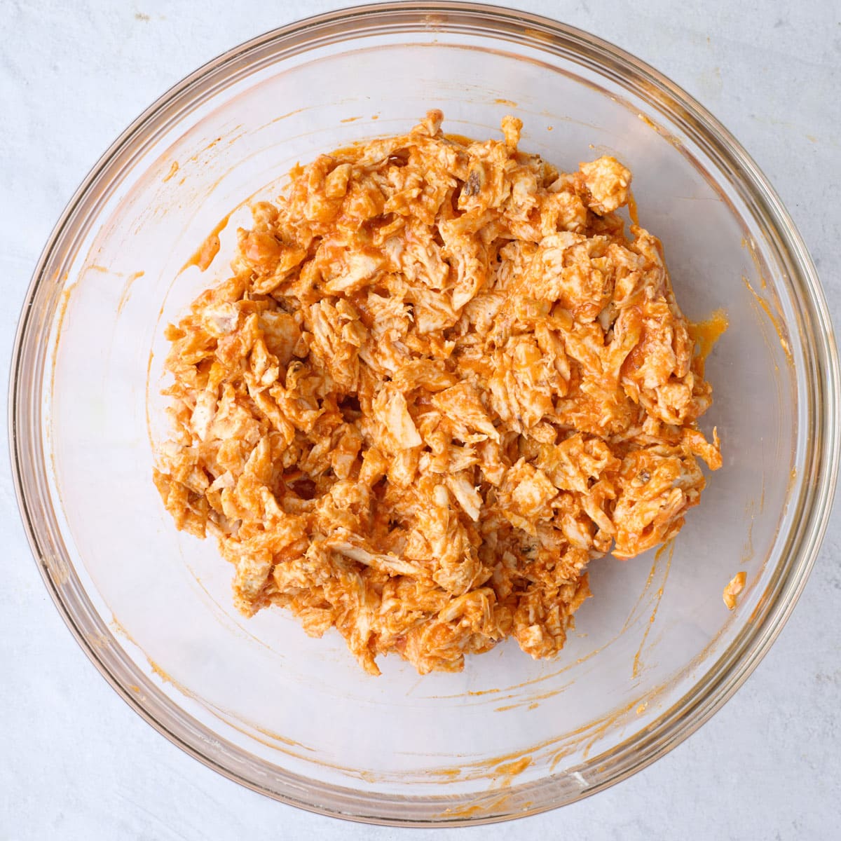 Shredded chicken and ranch after tossing together with buffalo sauce.