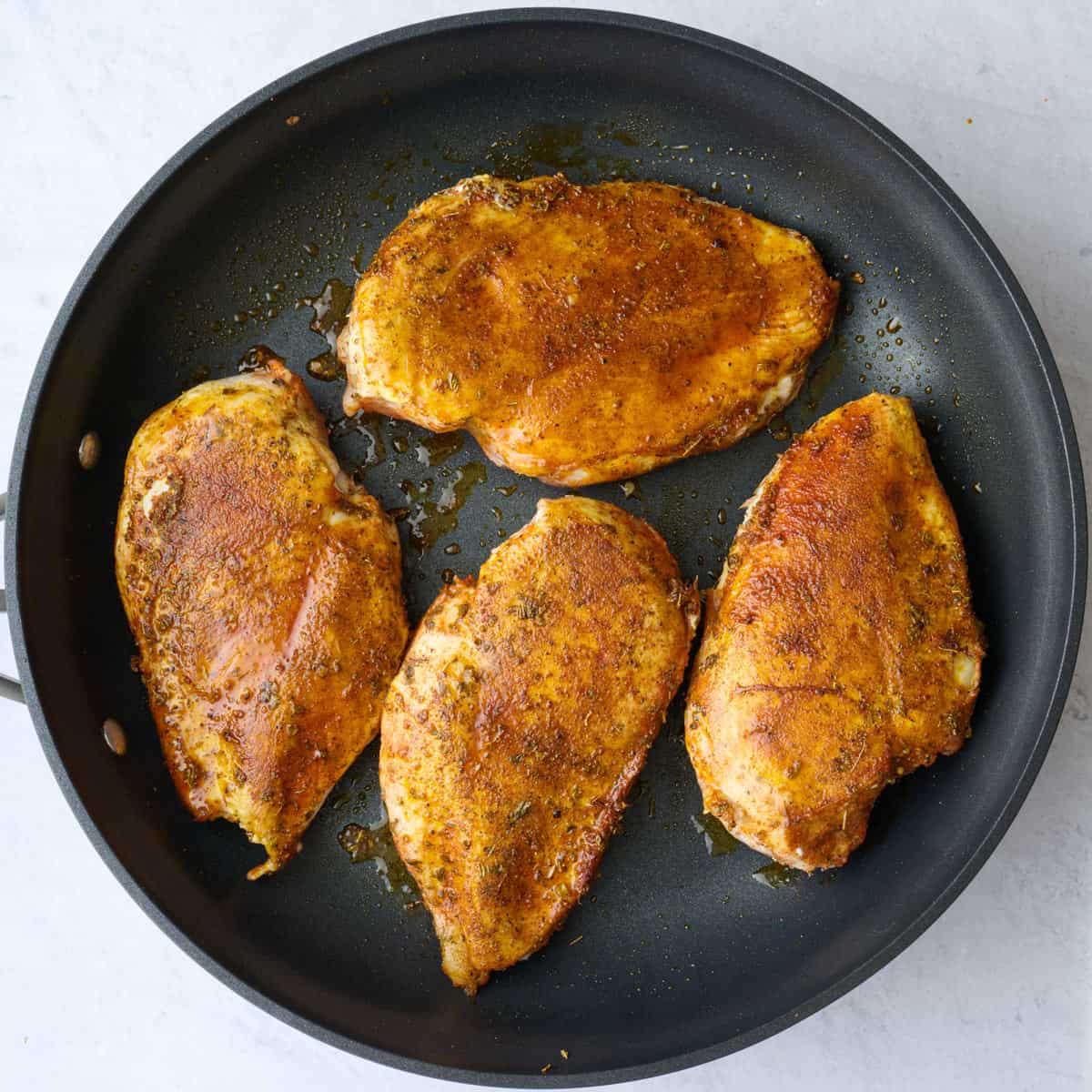 After flipping chicken and cooking until golden brown and cooked through.