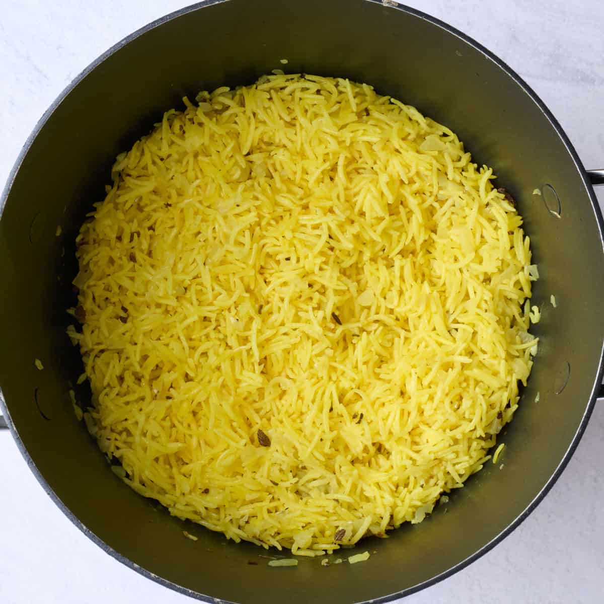 Turmeric yellow rice after cooking in pot.
