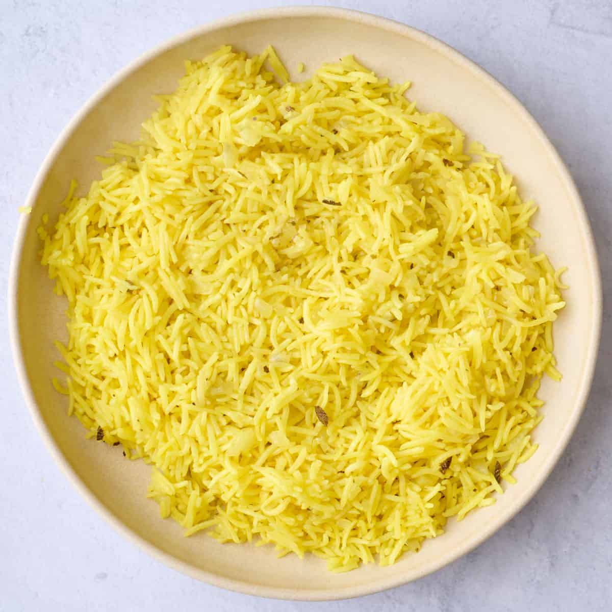 Cooked rice in a shallow bowl.