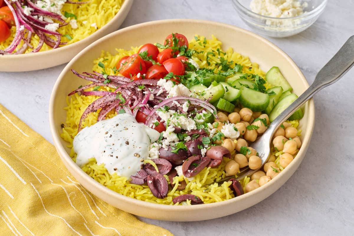 Vegetarian rice bowl with Mediterranean toppings.
