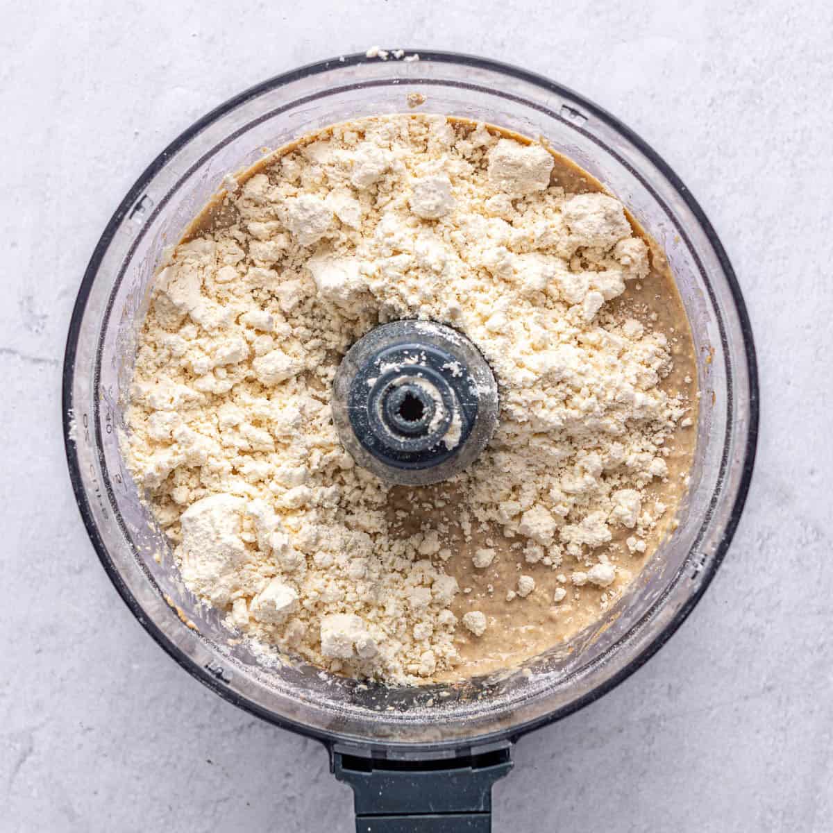 Wet ingredients after blending together with protein powder added on top.