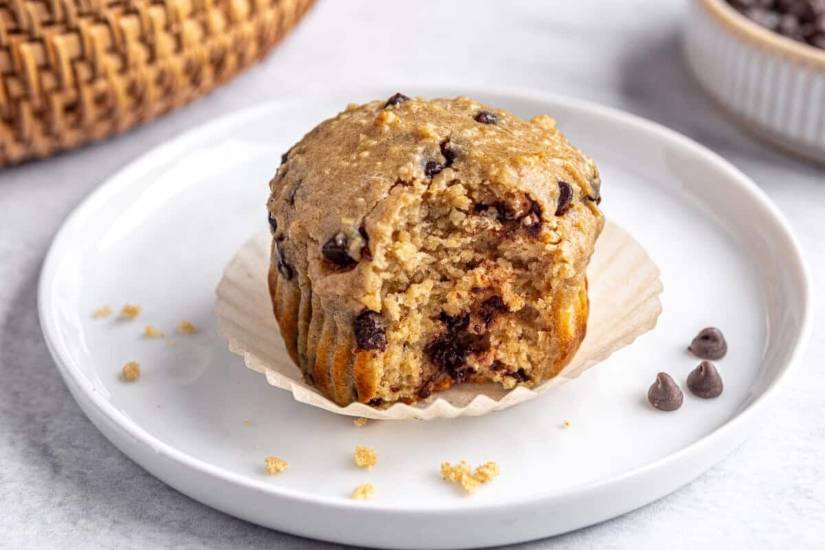 Protein muffins with protein powder on a plate with a bite taken out.
