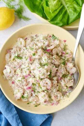 Best shrimp salad recipe served in a bowl and garnished with extra fresh dill.