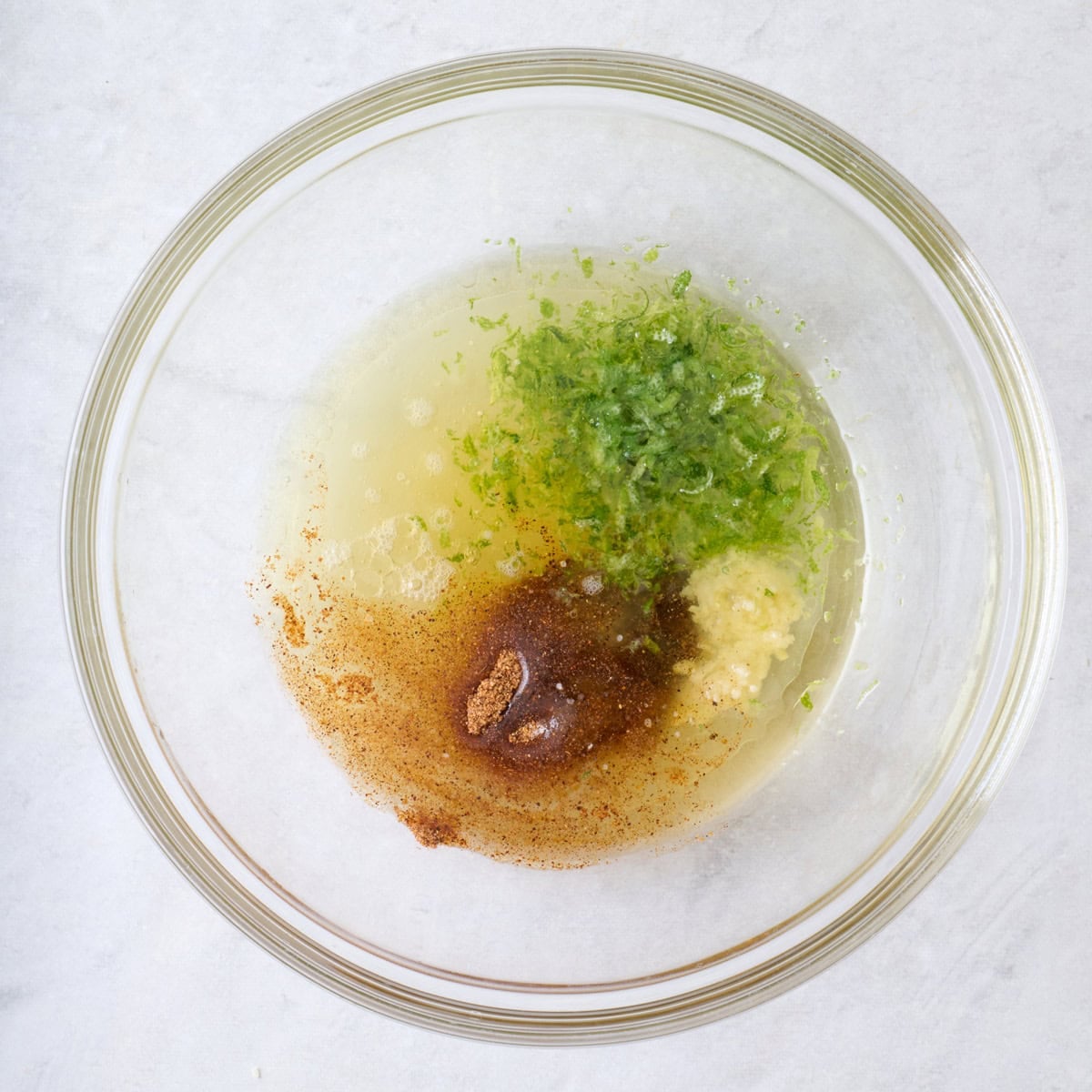 Dressing ingredients for pasta salad in a bowl before whisking.