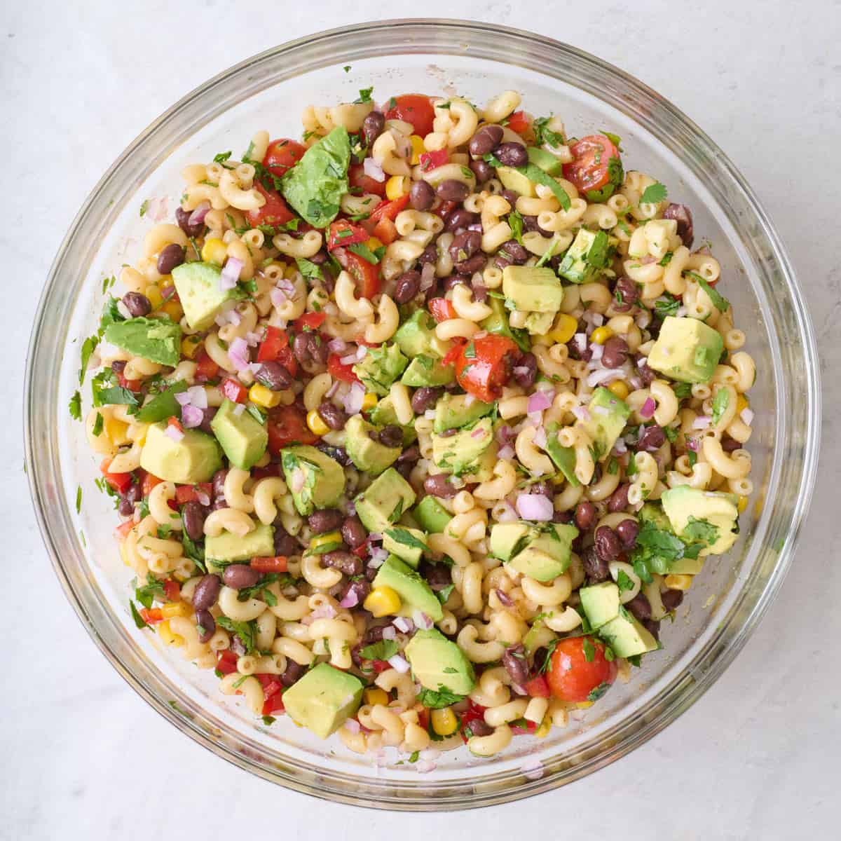 Diced avocado added to pasta salad with beans.