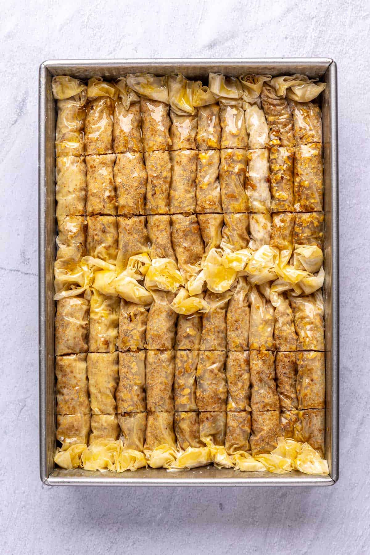 After cutting each roll into thirds and brushed with melted ghee before baking.