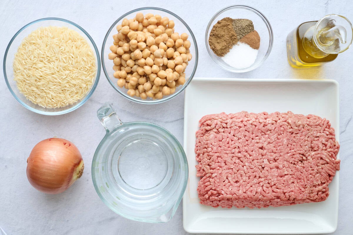 Ingredients for one pot dinner recipe: rice, chickpeas, onion, water, ground beef, spices, and oil.