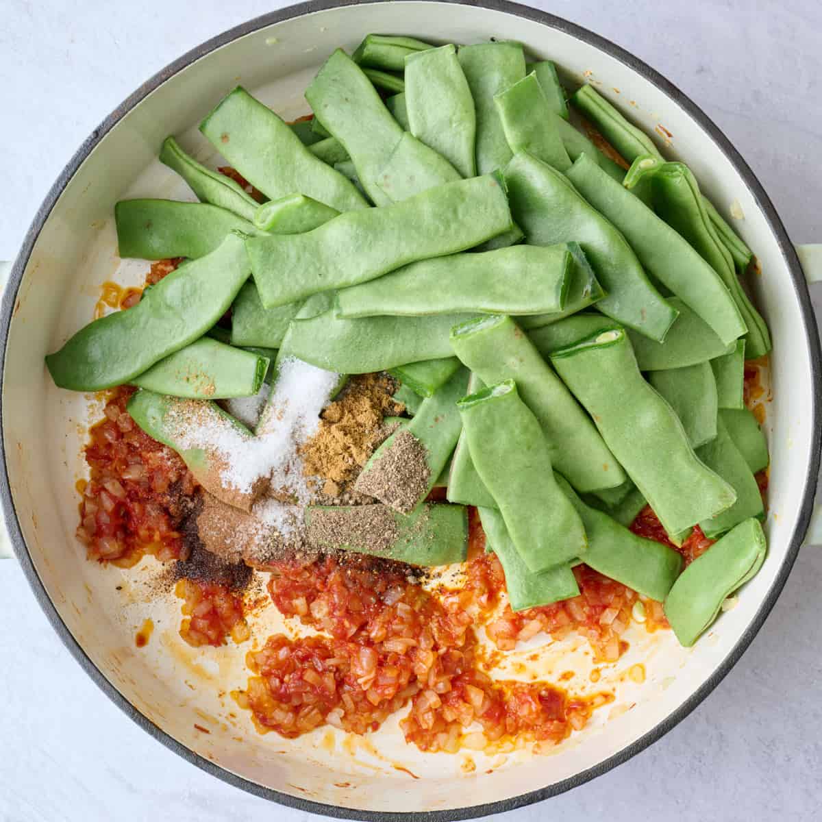 Flat italian green beans added to sauteed onions and tomato paste mixture before combining.