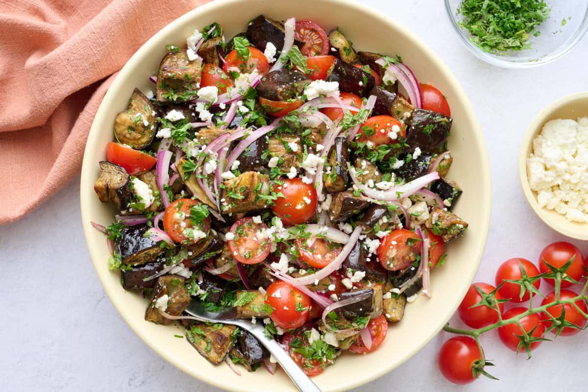 Best Mediterranean eggplant salad in a serving bowl garnished with extra feta.