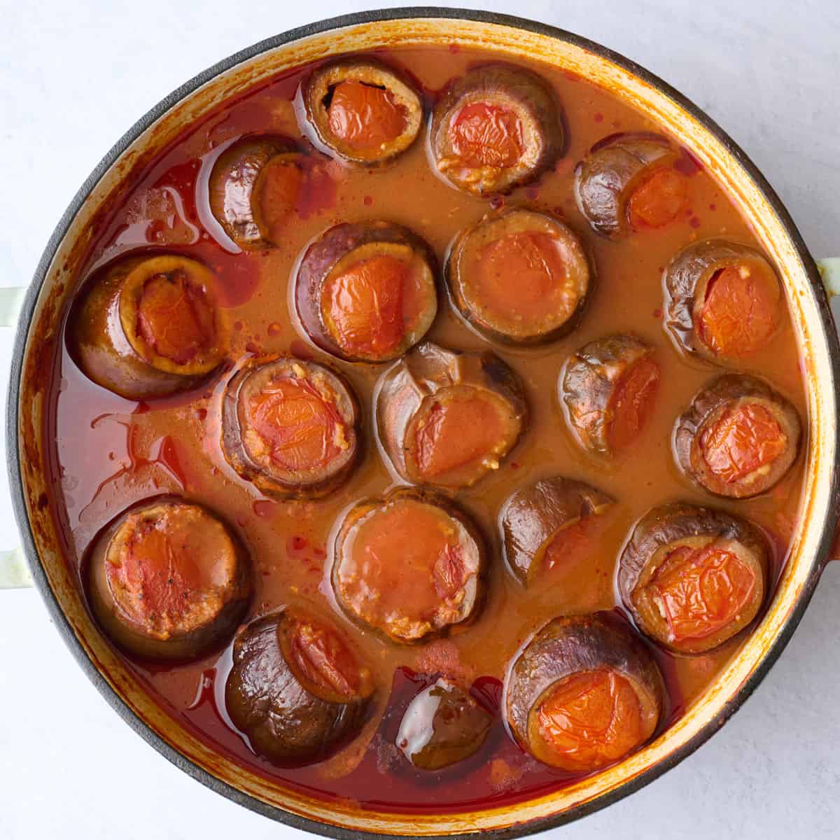Ground beef and rice stuffed eggplants after cooking in a tomato broth.