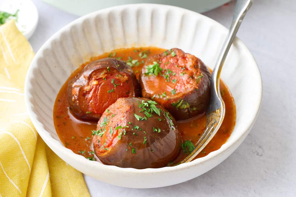 Stuffed baby eggplants in a rich tomato broth.