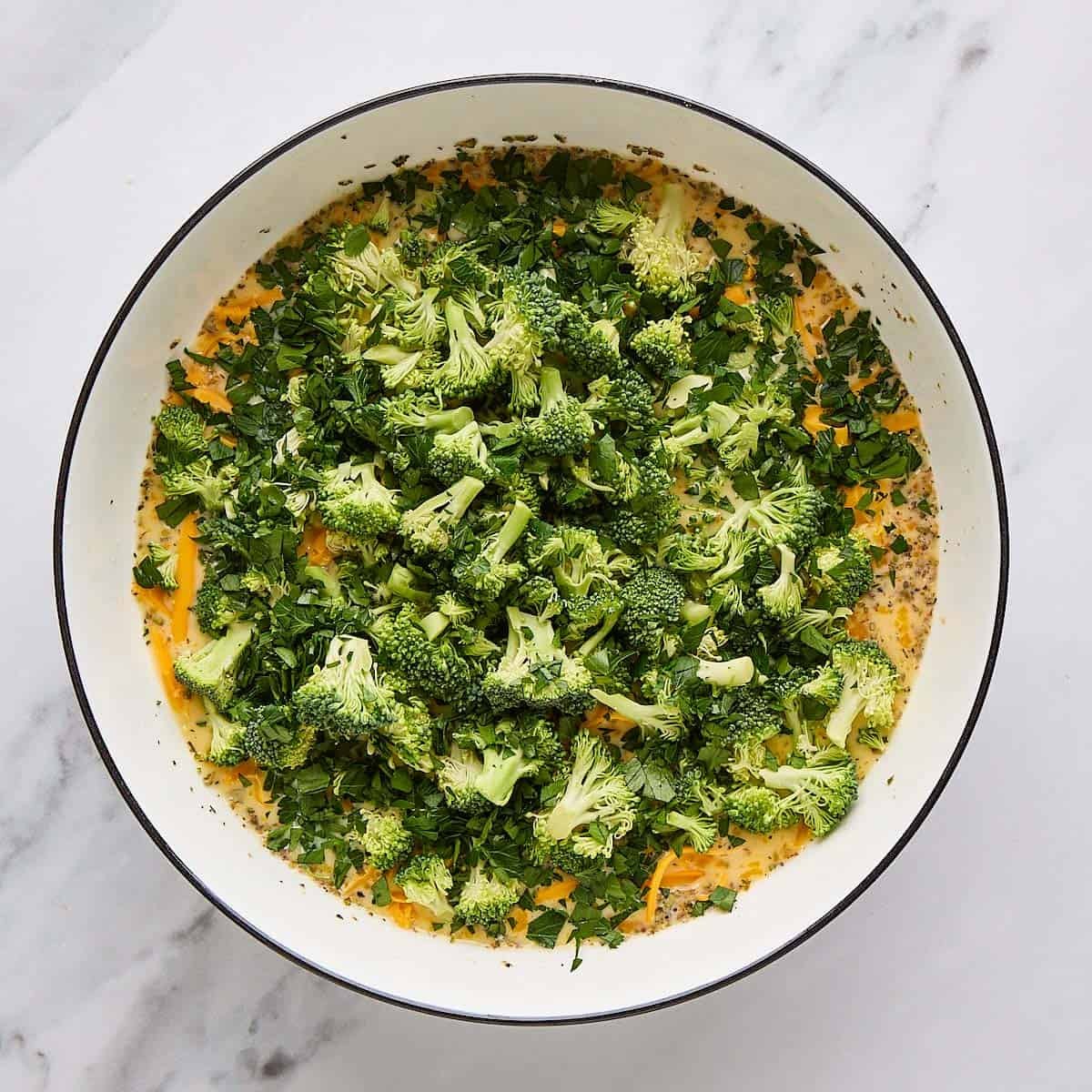 Broccoli florets and shredded cheese added to egg mixture.