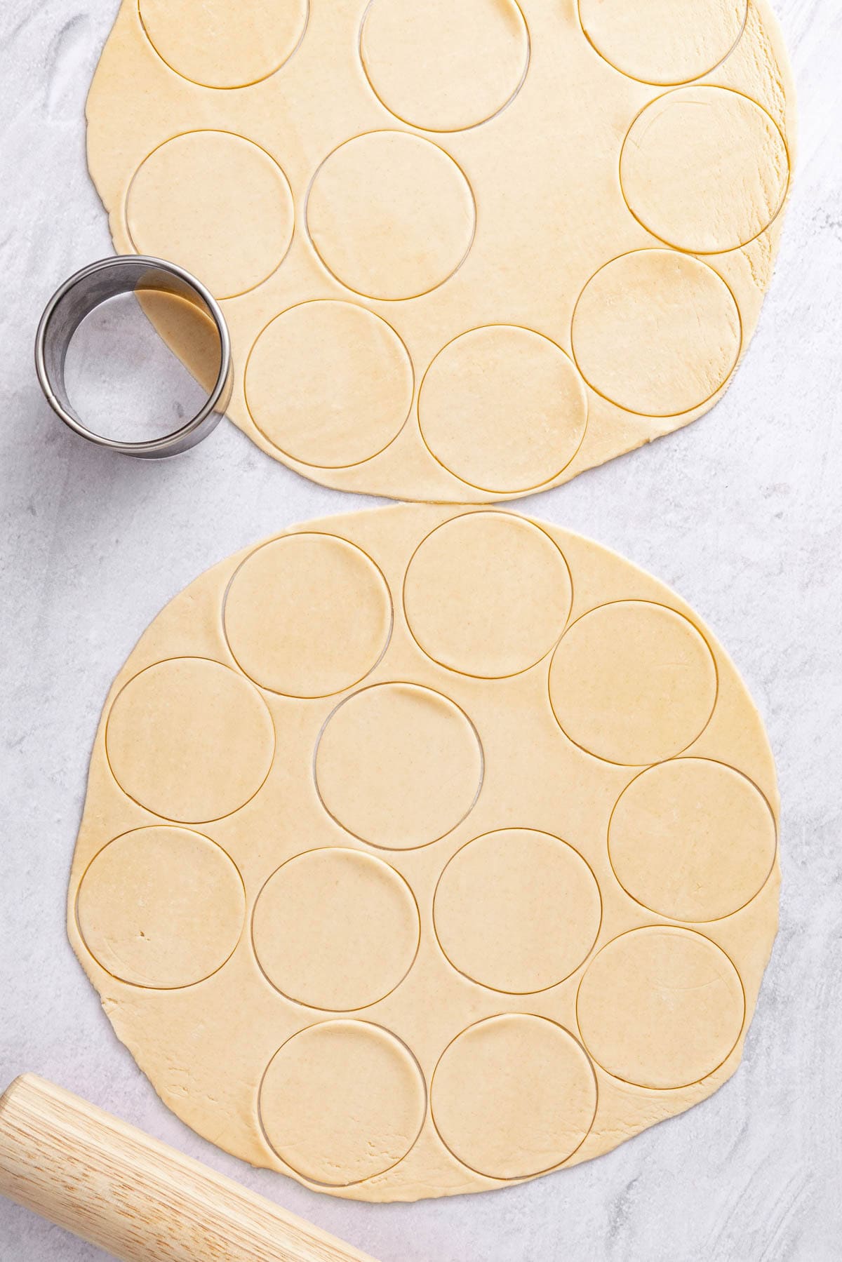 Pie crust rolled out with 3 inch rounds cut out.