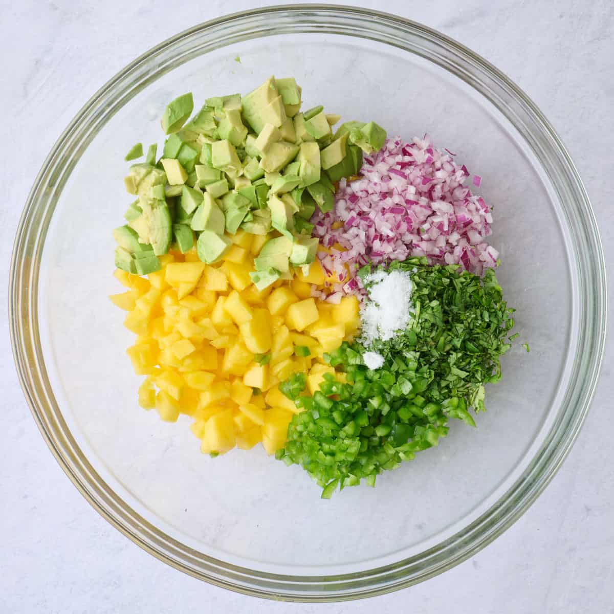 Mango, avocado, onion, cilantro and jalapeno, lime juice and salt before combining.