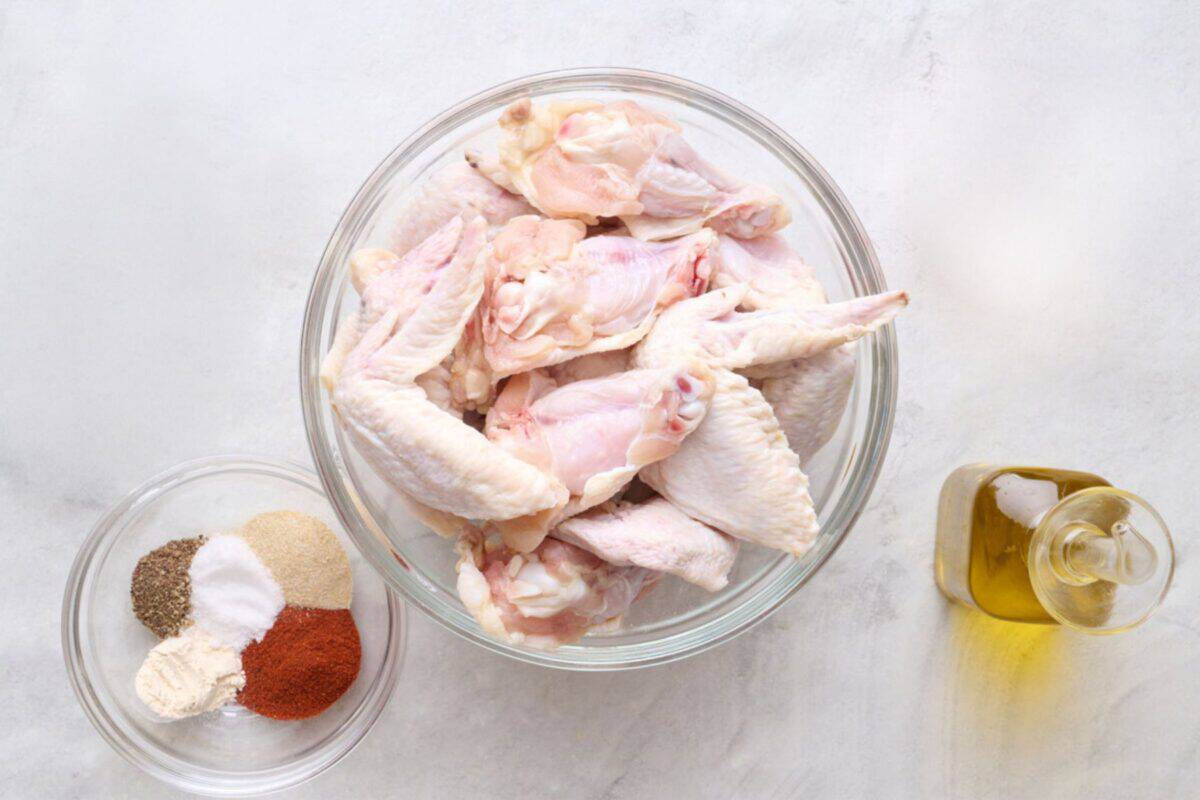 Ingredients for air fryer recipe: chicken wings, seasonings, and oil.