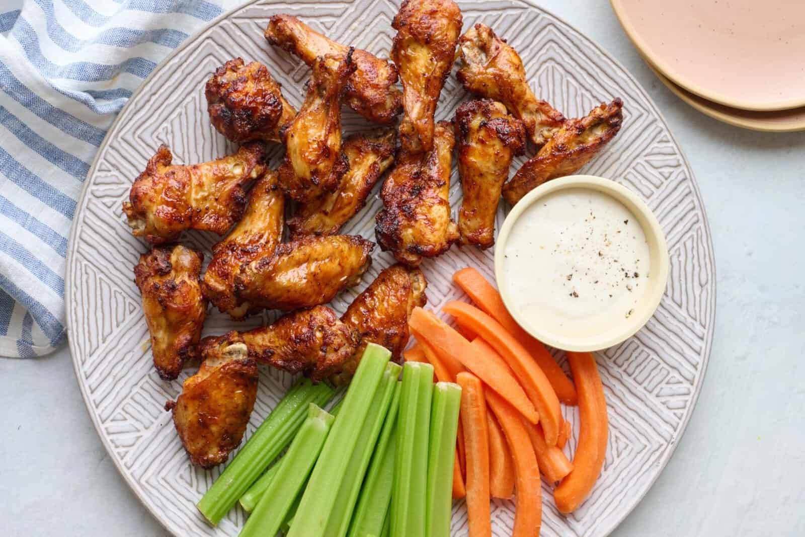 Crispy air fryer chicken wings served with carrots, celery and ranch.